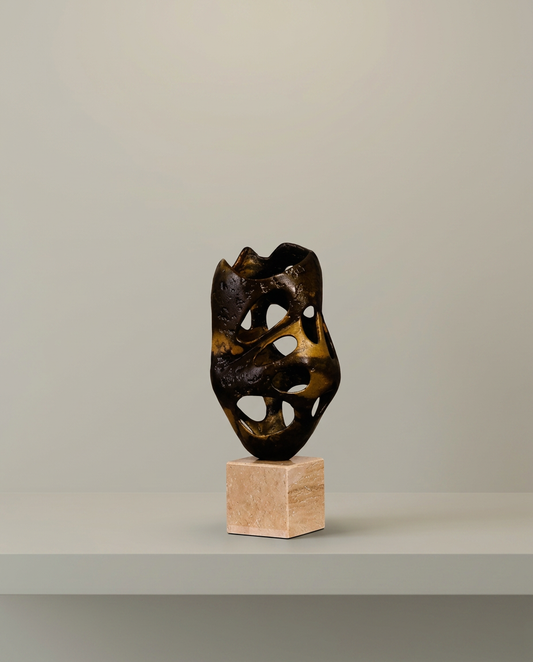 Perforated Bronze Sculpture, front view on neutral background