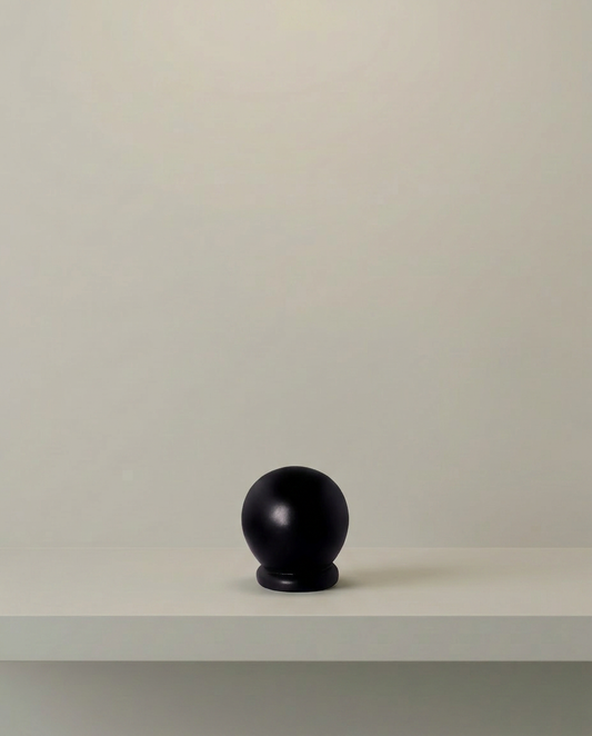 Dark Orb Sculpture, front view on neutral background